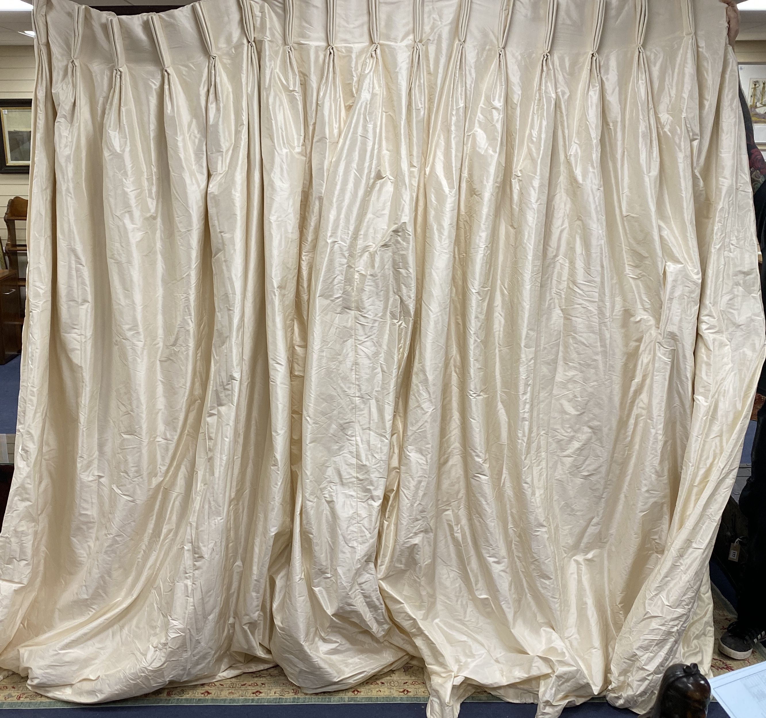 A large pair of cream silk curtains. 100 inches drop